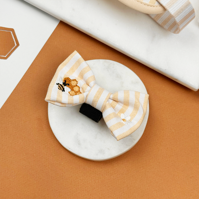 Pale yellow and white striped Dog Bow Tie with bee and honeycomb embroidered decals.