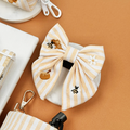Pale yellow and white striped Dog Sailor Bow Tie with bee and honeycomb embroidered decals.