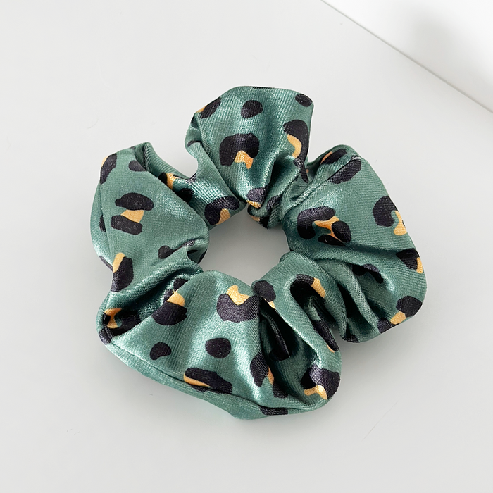 Khaki scrunchie with a brown and black leopard print pattern.