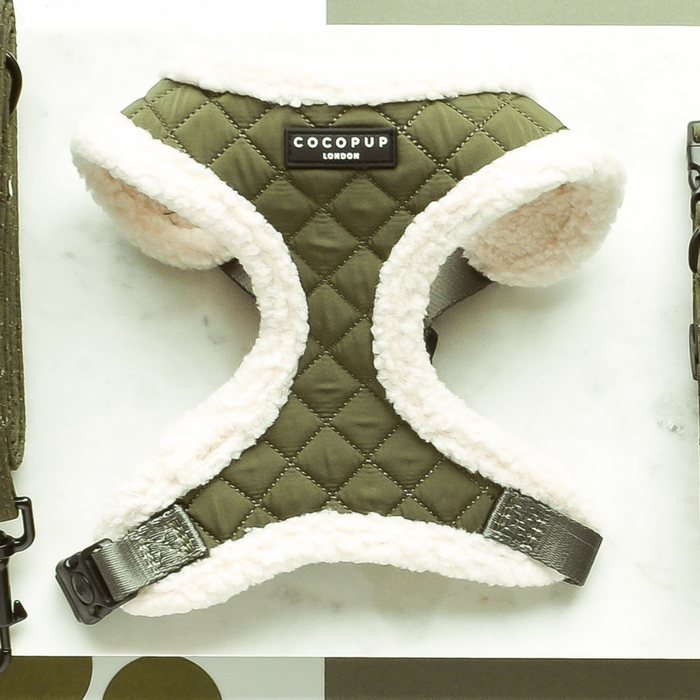 Khaki quilted dog harness with adjustable neck and white fleece lining, displayed on a white surface.