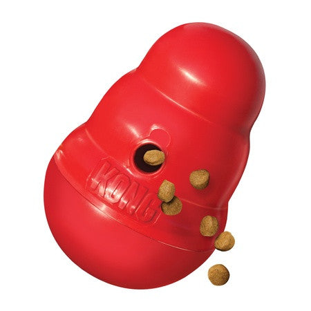KONG Wobbler tipped with kibble spilling from the dispensing hole