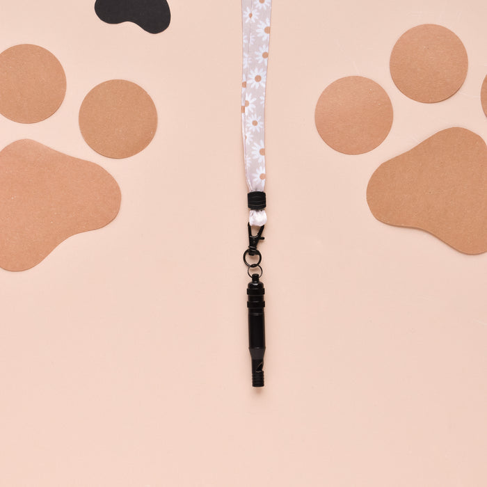 Cocopup London Daisy Chain lanyard with daisy pattern on a peach background with bold paw print shapes.