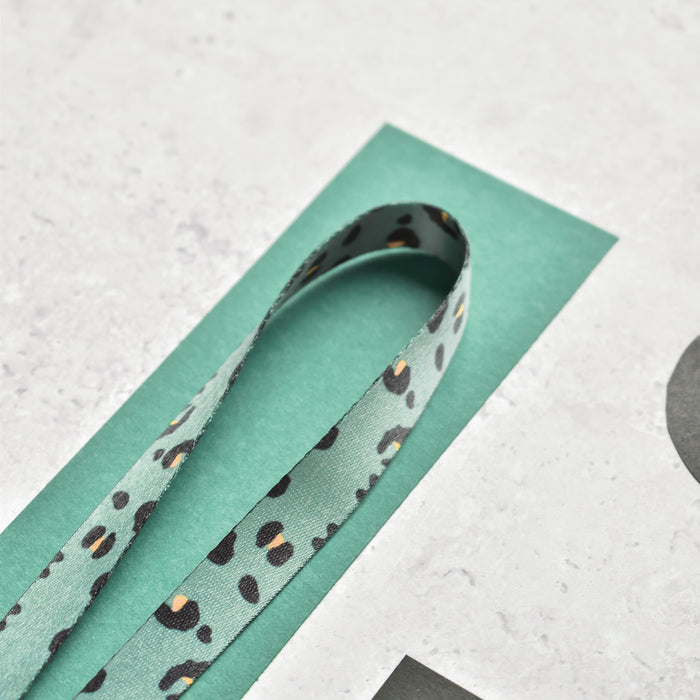 Khaki Cocopup London lanyard with a leopard print pattern in black and tan spots.