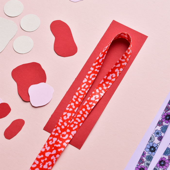 Red and pink leopard print Cocopup London lanyard with metal clasp and durable fabric strap.