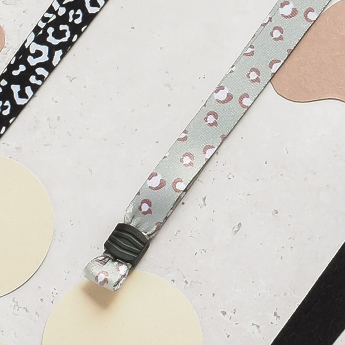 Two Cocopup London lanyards with patterned designs and cream tags on a speckled background.
