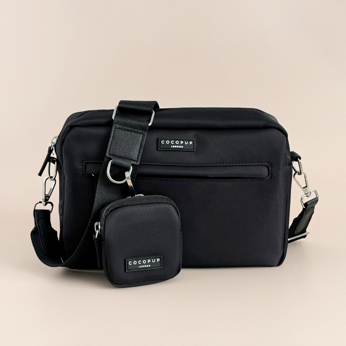 Black Cocopup London LARGE dog walking bag with attached treat pouch on a beige background.