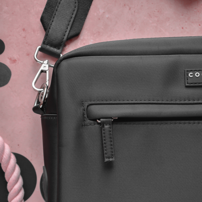 Black Cocopup London dog walking bag, large size, with zipper, metal clasp, and built-in poop bag dispenser.