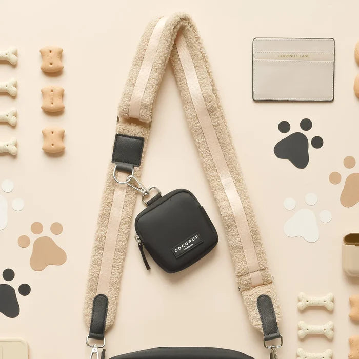 Black Cocopup London dog walking bag with beige fuzzy strap, matching treat pouch, and cardholder attached.