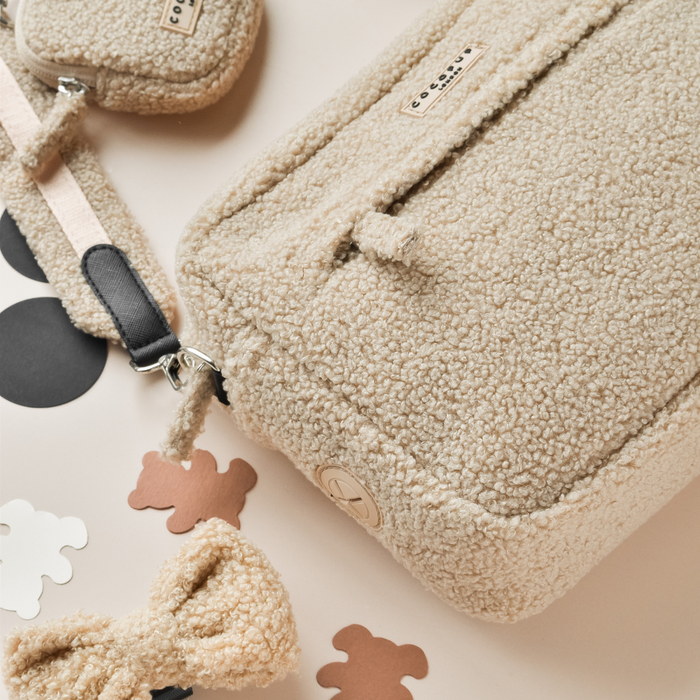 Large tan teddy-fleece dog walking bag with matching bow, treat pouch, and bear paw-shaped cutouts.