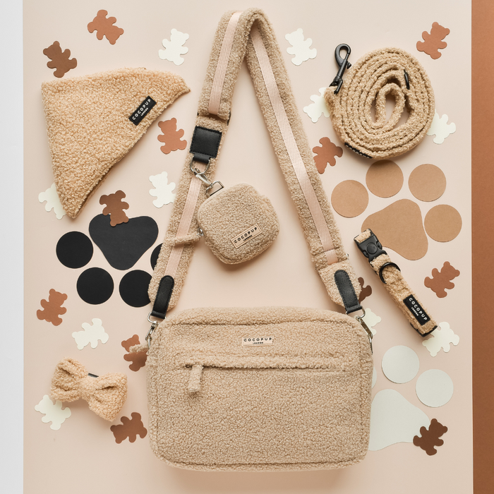 Cocopup London Teddy Rupert dog walking set in soft beige fleece with matching bag, lead, collar, bandana, bow, and dispenser.