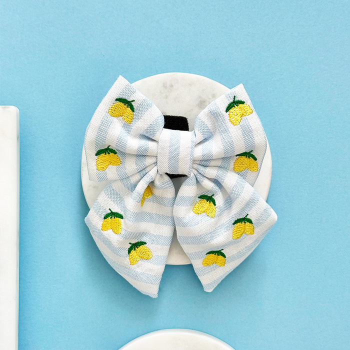 Light blue striped sailor bow tie with embroidered yellow lemons by Cocopup London.