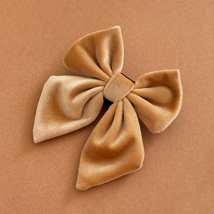 Mocha velvet sailor bow tie with four loops, displayed on a matching tan background.