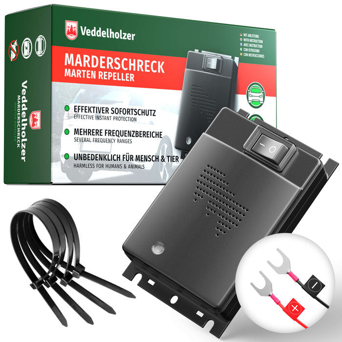 Grün-rote Verpackung, davor das flache schwarze Gerät mit Kippschalter, dazu Kabelbinder und Batterie-Klemmkabel