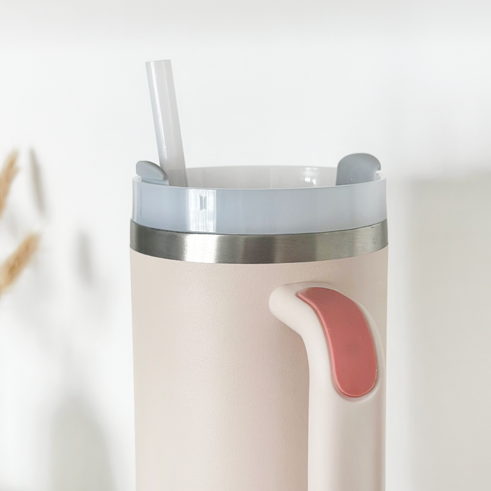 Marshmallow pink stainless steel tumbler with lid and straw, Cocopup London branding on the side.