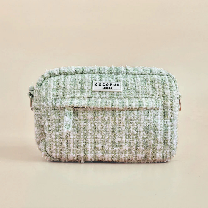 Green textured tweed dog walking bag bundle with front pocket and treat pouch on a beige background.