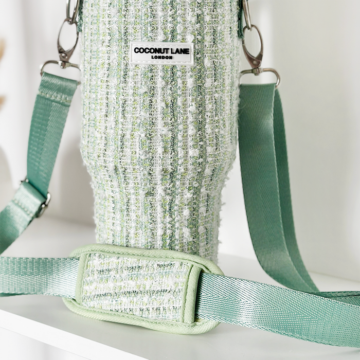 Green textured tweed tumbler carry case with strap and Cocopup London label on a white surface.