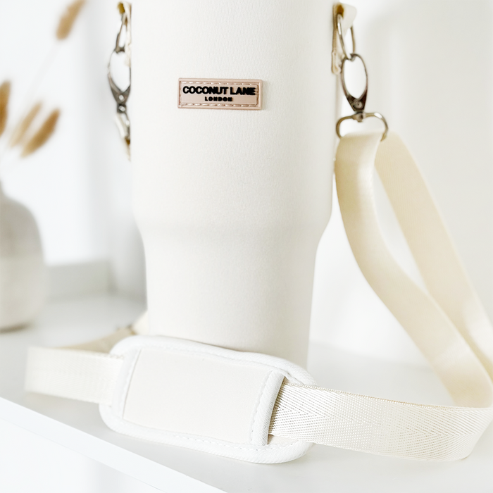 Milky Coconut tumbler carry case with cream strap, cup holder, and Cocopup London logo detail.