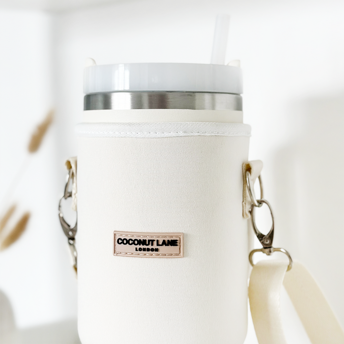 White insulated tumbler with straw inside a cream Cocopup London carry case.