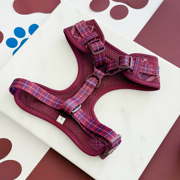 Mulberry plaid adjustable neck dog harness on a white surface with brown and blue paw prints.
