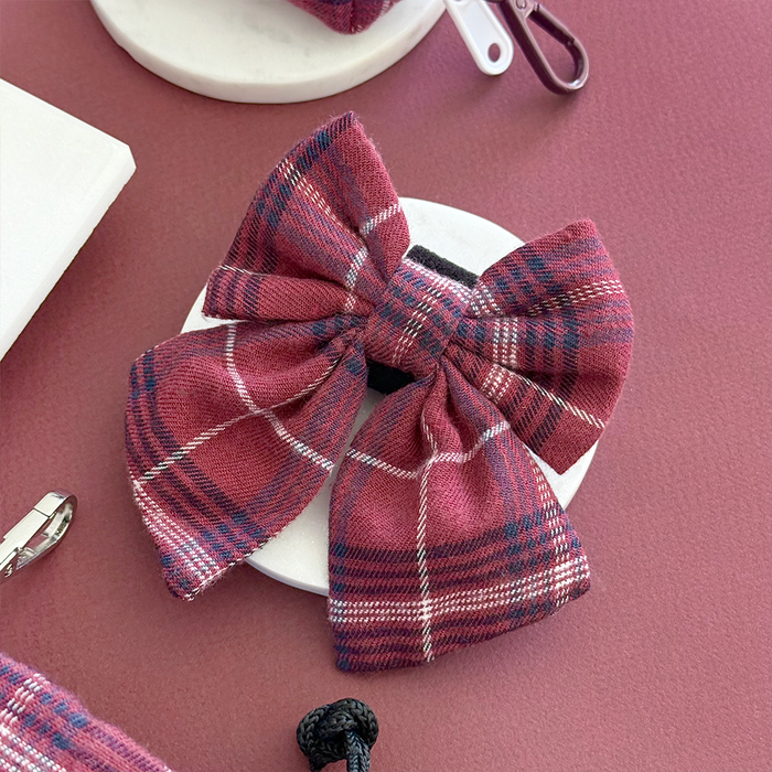Mulberry plaid sailor bow tie by Cocopup London on a white display with a mauve background.
