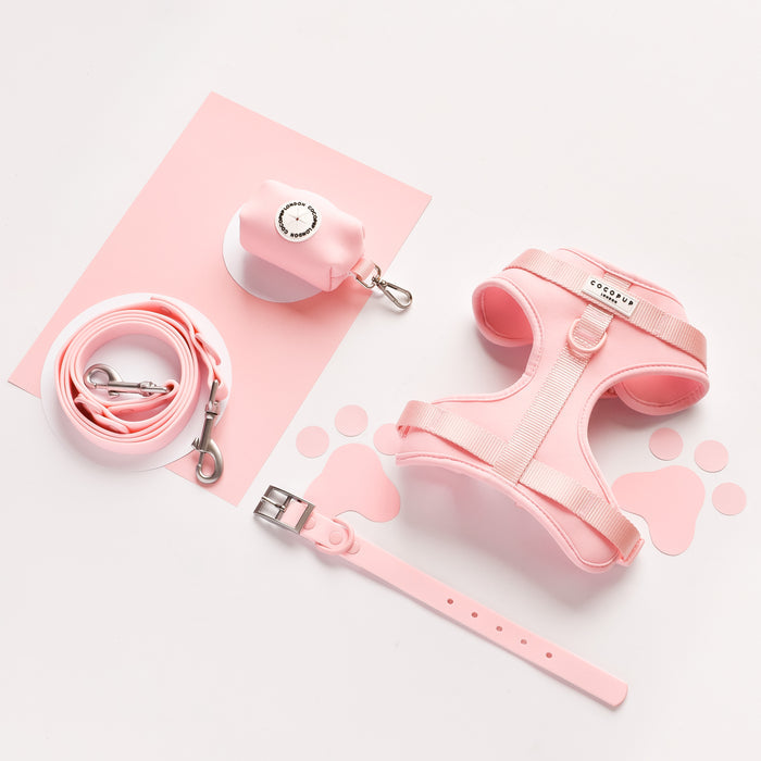 Pink adjustable neck harness with matching leash, collar, and waste bag holder from Cocopup London.