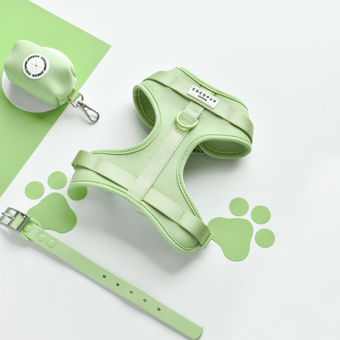 Matcha green adjustable neck harness, collar, and white waste bag holder with green paw prints.