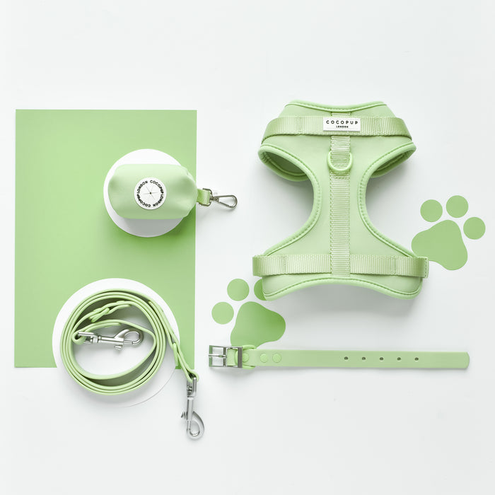 Matcha green Cocopup London harness set with adjustable neck, leash, collar, waste bag holder, and paw print cutouts.