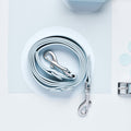 Blue Cocopup London NAKD Lead with metal clasps, coiled neatly on a pale background.