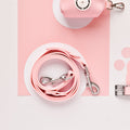 Candyfloss pink Cocopup NAKD lead, collar, and waste bag holder on a light pink and white background.