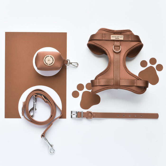 Brownie brown Cocopup London NAKD Poop Bag Holder with gold zipper on a plain white background.