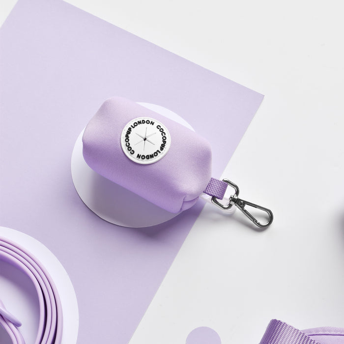 White and purple Cocopup London poop bag holder with a metal clip and round logo.