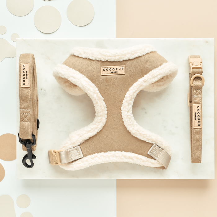 Tan suede dog harness with sherpa trim, matching collar, and nude lead with faux suede handle.