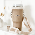 Nude tumbler carry case with fuzzy trim, cross-body strap, and stainless steel cup by Cocopup London.