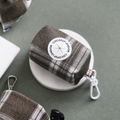 Olive check patterned poop bag holder with a white clip by Cocopup London.