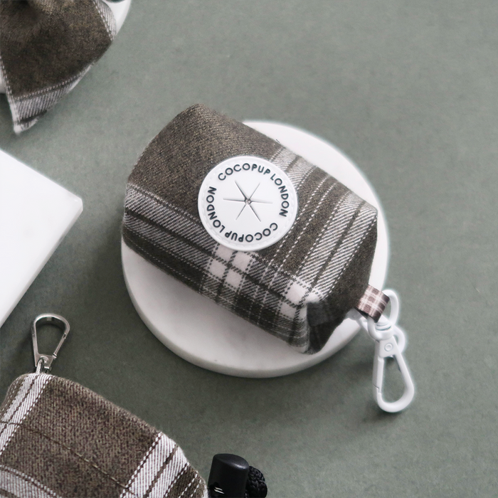Olive check patterned poop bag holder with a white clip by Cocopup London.