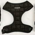 Black quilted dog harness with adjustable neck, comfy straps, and a secure buckle.