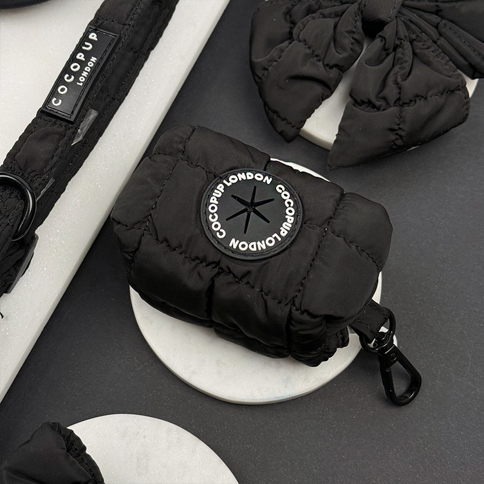 Black quilted Cocopup London poop bag holder with matching quilted leash and dog accessories.
