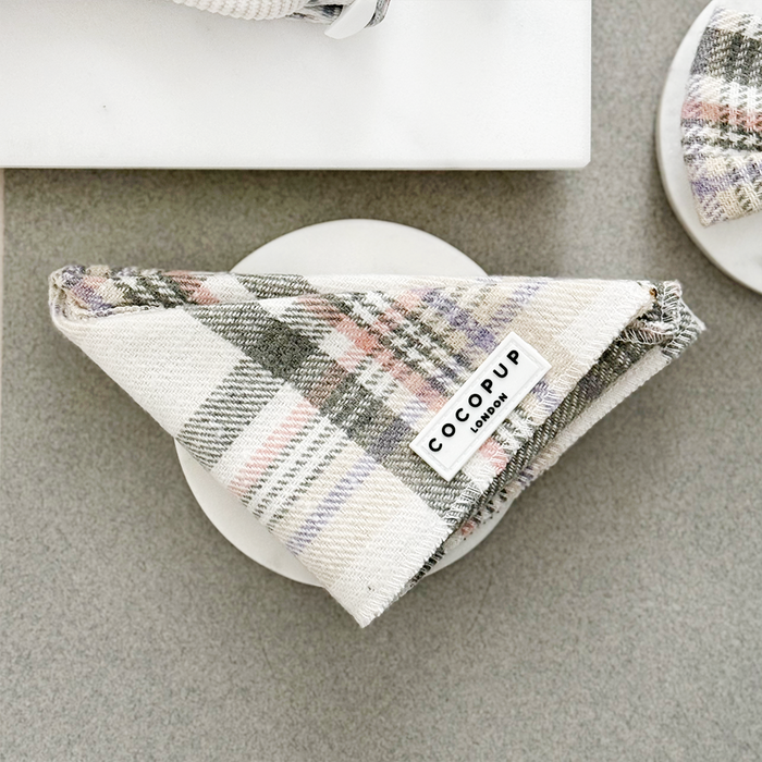 Beige and pink plaid bandana by Cocopup London, neatly arranged on a white plate.