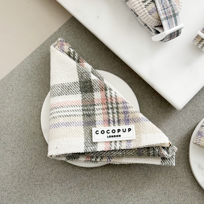 Oxford plaid bandana from Cocopup London displayed on a white coaster atop a gray surface.