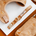 Beige adjustable dog collar from Cocopup London with subtle embroidered swirl patterns.