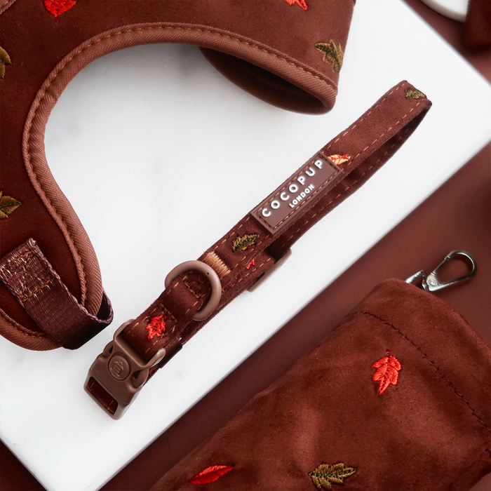 Burgundy velvet dog collar set with a safety buckle, matching harness, and a poop bag holder, all in a leaf pattern.