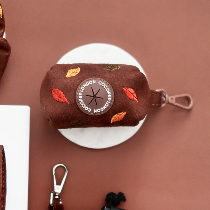 Cocopup London poop bag holder with embroidered autumn leaves and metal clip, in soft fabric with leaf pattern.