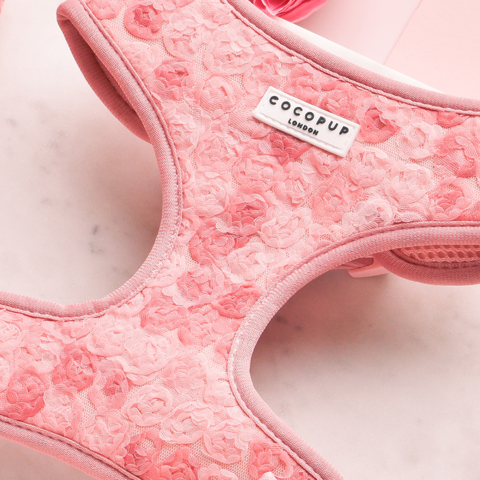 Pink floral adjustable dog harness from Cocopup London, displayed on a light marble surface.