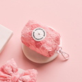 Pink floral Peony Pup poop bag holder by Cocopup London next to a matching pink lace bow.