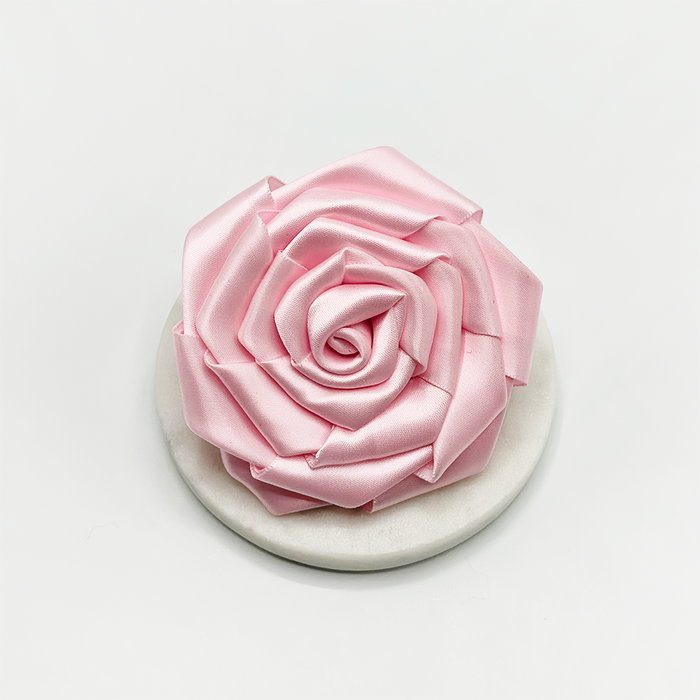 Pink satin rose-shaped collar flower accessory for dogs by Cocopup London.