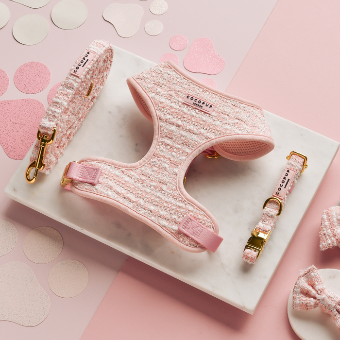 Pink textured tweed dog harness, lead, and collar set from Cocopup London displayed on a marble surface.
