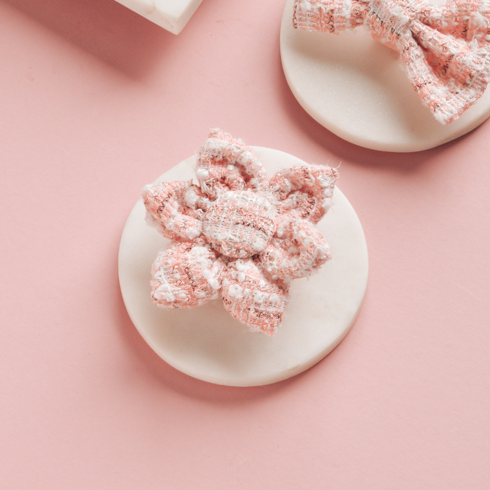 Pink textured tweed collar flower and matching bow clip from Cocopup London on pink and white backgrounds.
