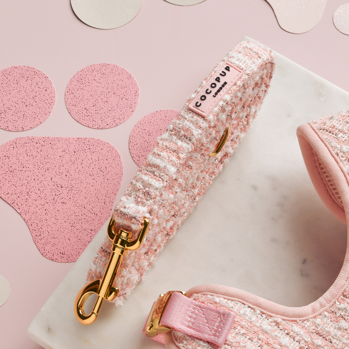 Pink textured tweed dog harness, lead, and collar set from Cocopup London displayed on a marble surface.