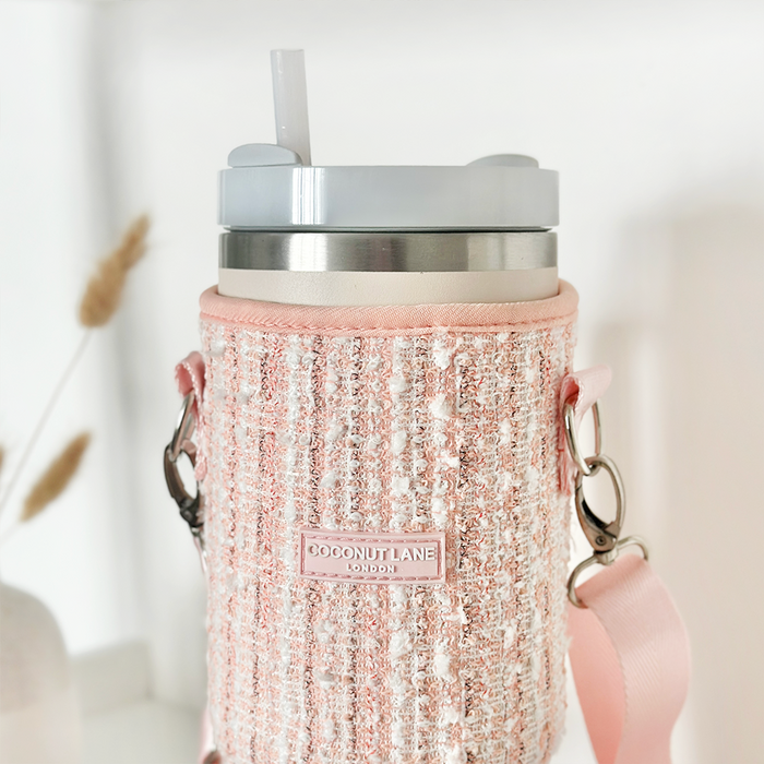 Pink textured tweed tumbler carry case with a silver tumbler inside, featuring a gray lid and straw.