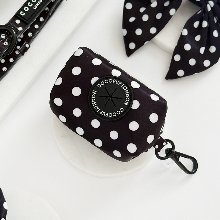 Polka dot poop bag holder with round Cocopup London label and metal clip.